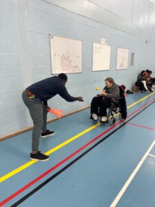 An ALFIE student in a wheelchair playing catch